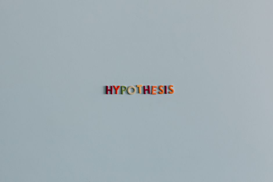 Colorful letters spell out 'HYPOTHESIS' centered on a pale blue-gray background.